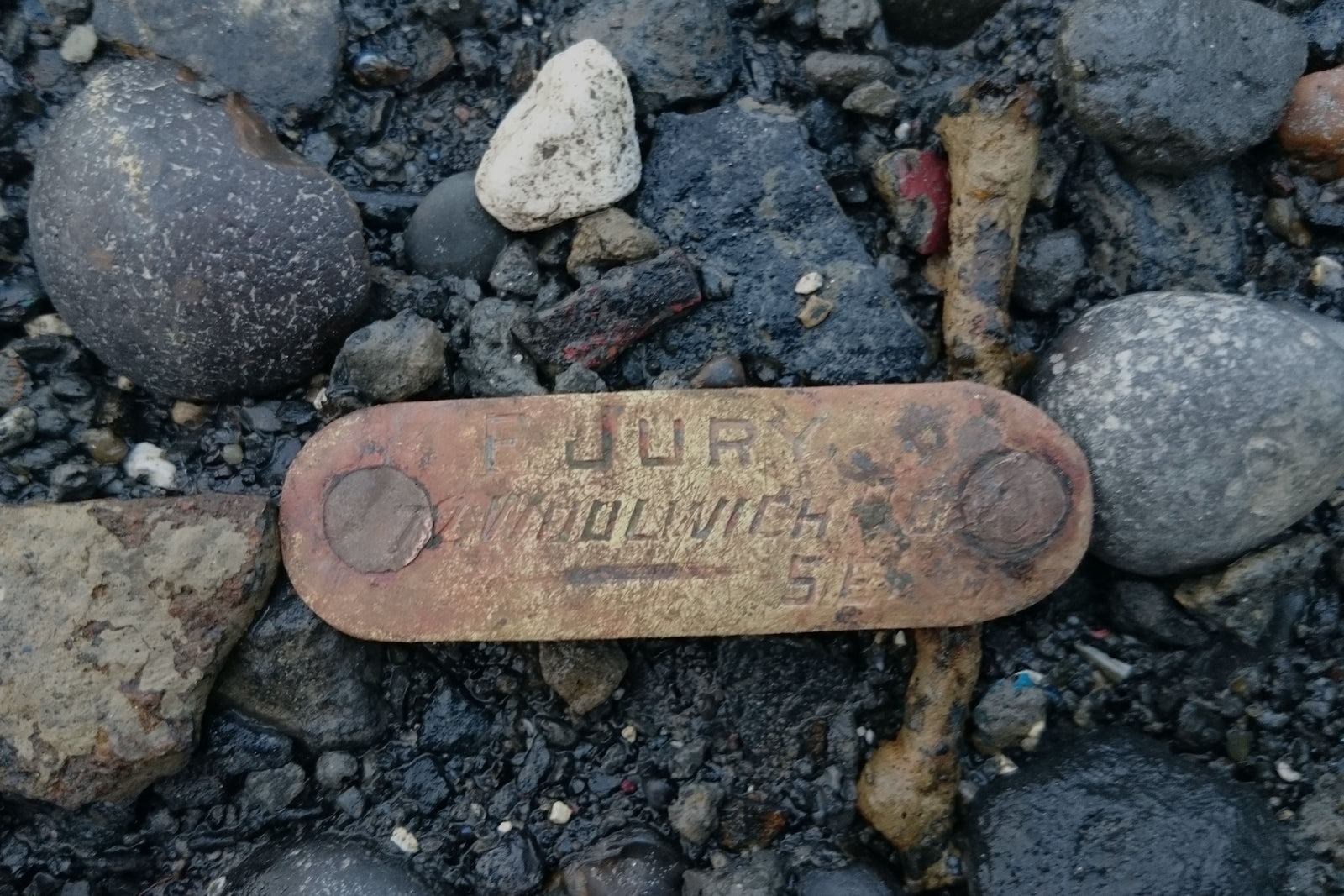 A small piece of brass with the name Frederick Jury engraved on it