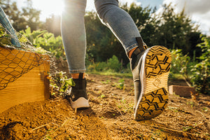 Person walking through an allotment in a pair of Outscape Trainers