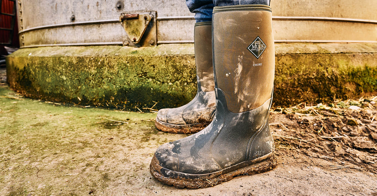 A pair of muddy Muck Boots Chore Wellingtons.