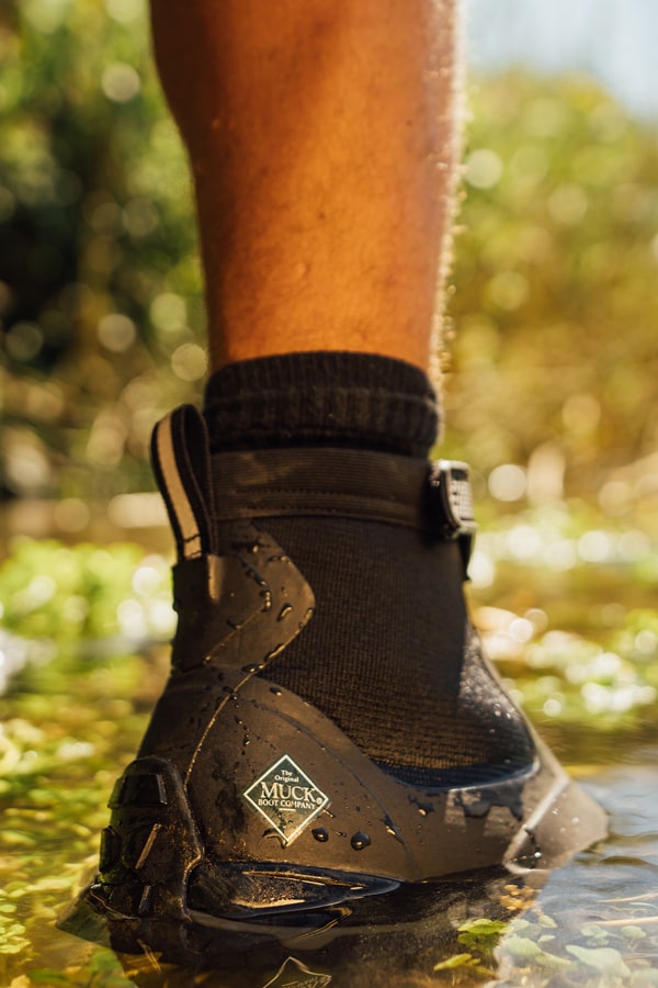 Close-up image of a pair of Muck Boots Apex boots in water