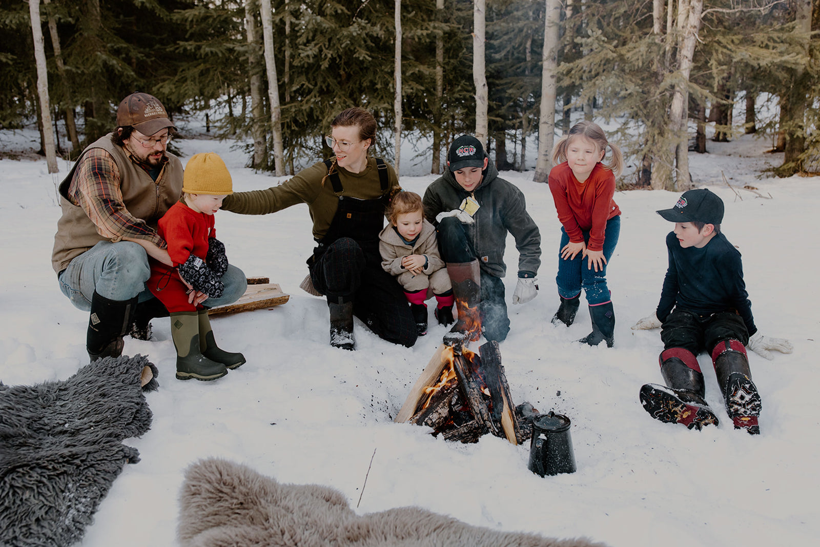 Kate Schat and her family sat in front of a fire in the snow