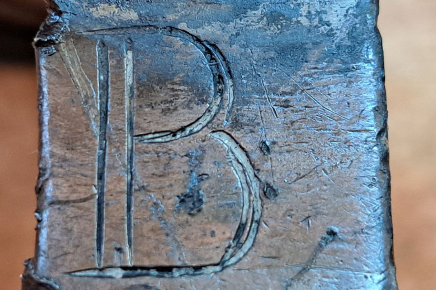 Letter B engraved on a metal pewter tavern mug handle