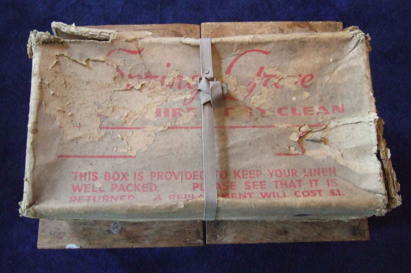 An old dusty box secured with a thin strap