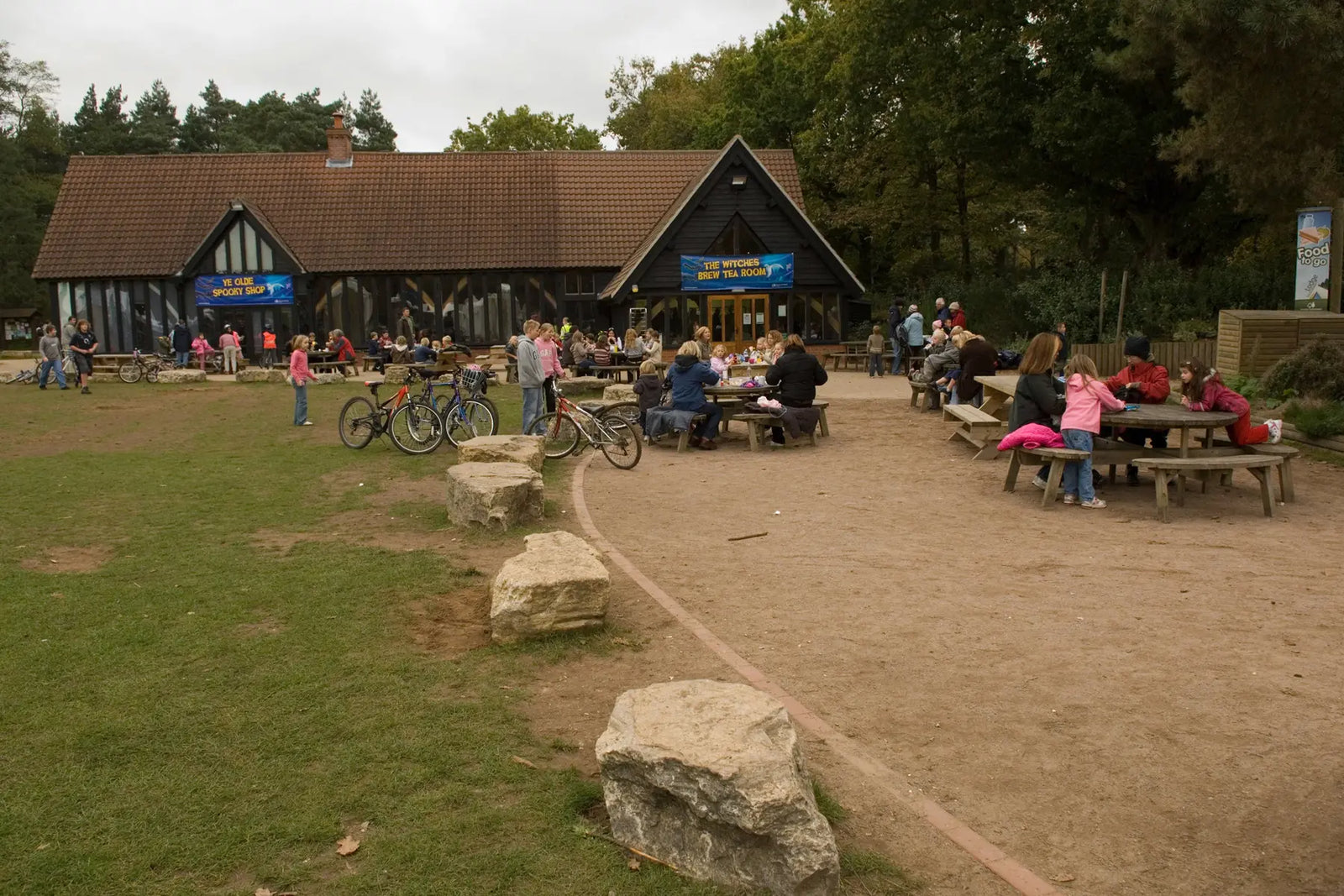 High Lodge tea rooms and outdoor area with benches and families sat together.