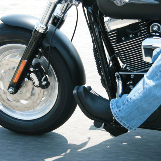 Close up image of a person riding a motorcycle, wearing a pair of Durango Harness boots