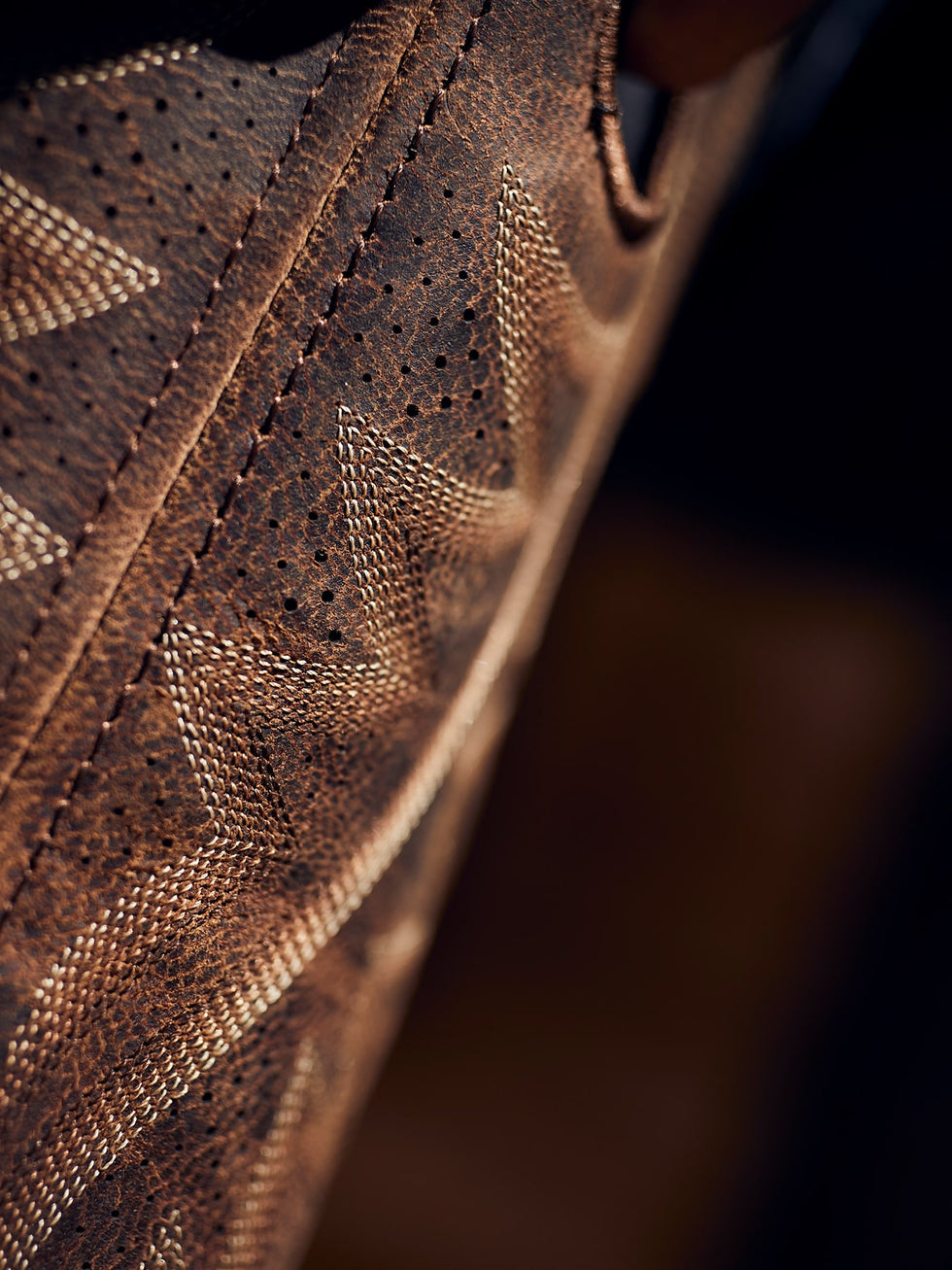 Close up texture of a Durango boot on a black background