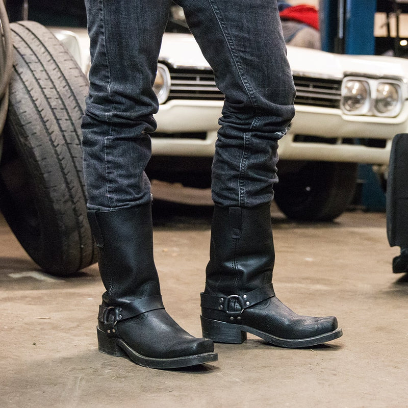 Close up of a man stood in a garage, wearing a pair of Durango Men's Harness Biker Boots