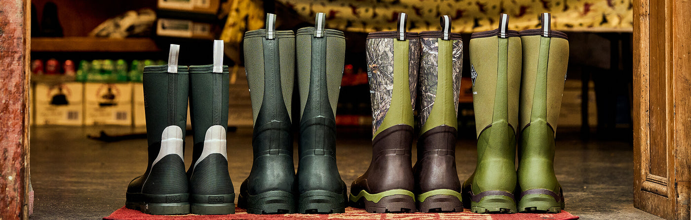 The backs of four pairs of Muck Boots Wellingtons inside a shed doorway